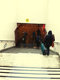 Young woman standing by railing