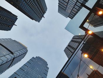 Low angle view of skyscrapers against sky at night