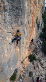 High angle view of people walking on rock