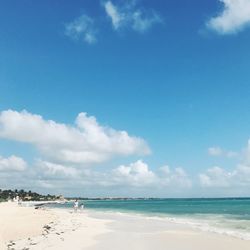 Scenic view of beach against blue sky