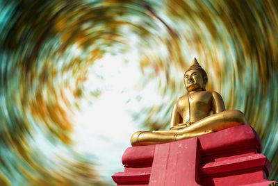 Low angle view of statue against temple building