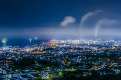 High angle view of illuminated cityscape against sky at night