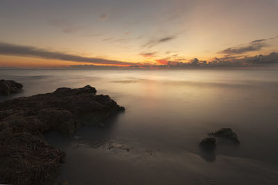 Scenic view of sea against sky at sunset