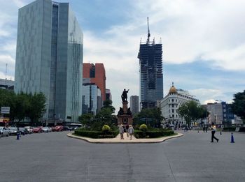 Buildings against cloudy sky