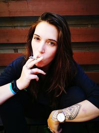 Portrait of young woman smoking