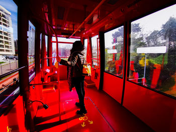 Rear view of man standing on train window