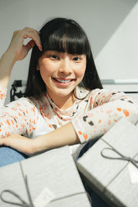 Portrait of young woman sitting in shopping cart