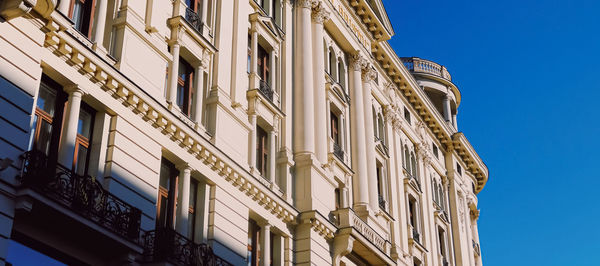 Low angle view of building against clear blue sky