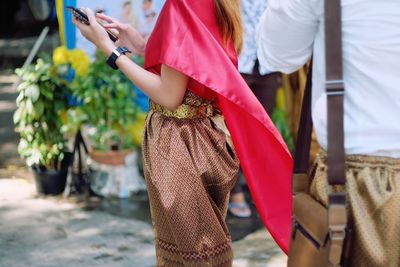 Midsection of woman using mobile phone