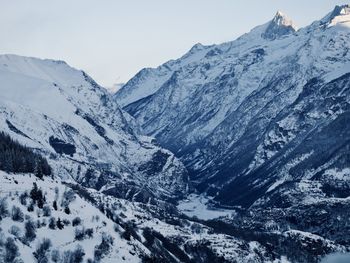 Scenic view of snowcapped mountains against clear sky