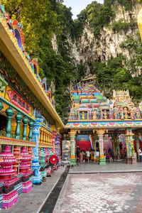 Multi colored statues on building outside temple