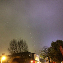 Low angle view of illuminated street light against sky