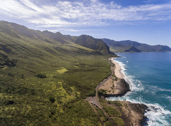 Scenic view of sea and mountains against sky