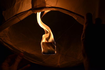 Low angle view of lit paper lantern at night