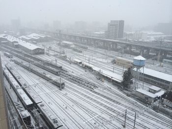 High angle view of railroad tracks in city during winter