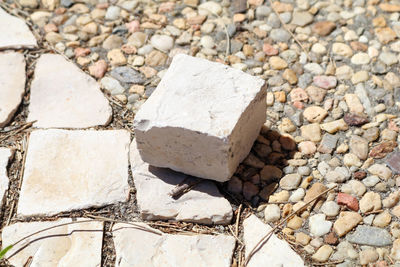 High angle view of rock on paved footpath