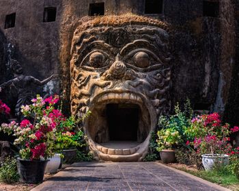 Statue against plants