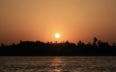 Scenic view of sea against orange sky