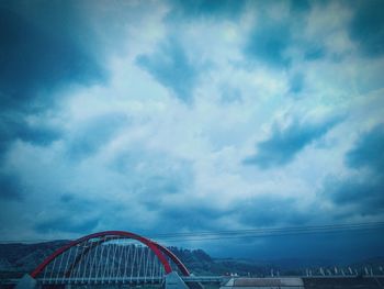 Low angle view of bridge against sky in city