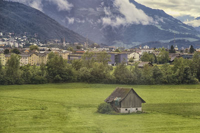 Houses on mountain against sky