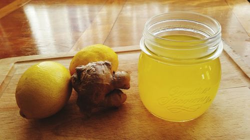 Tea by lemons and ginger on tray at home