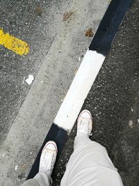 Low section of man standing on street