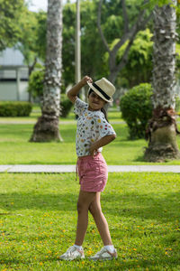Rear view of woman standing on field