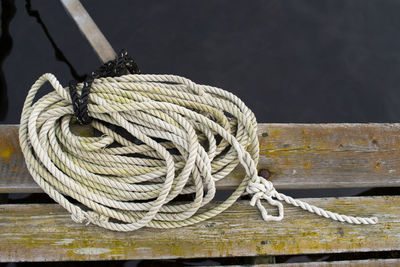 High angle view of rope by lake on wooden pier