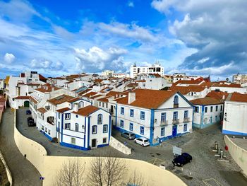 Buildings in town against sky