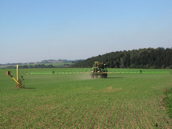 Scenic view of agricultural field against clear sky