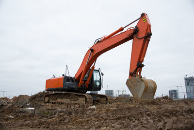 Excavator working at construction site on earthworks. backhoe digs ground for the foundation 