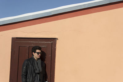 Young man standing by door 