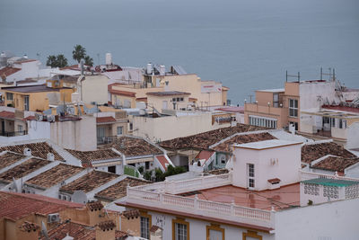 High angle view of townscape by sea