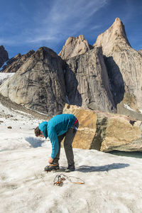 Full length of man on rocky mountains against sky