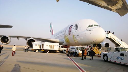 Airplane on runway against sky