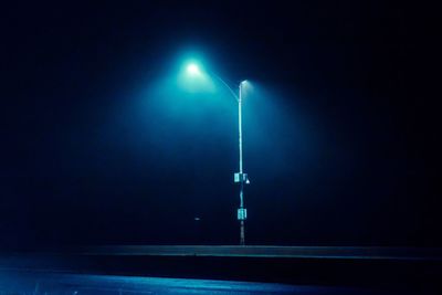 Low angle view of illuminated street light at night