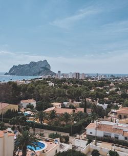 High angle view of buildings and sea against sky