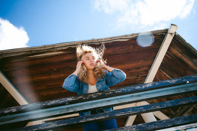 Low angle view of woman standing at observation point against sky