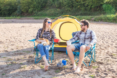 Young couple sitting on land