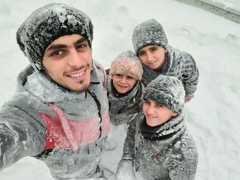 Portrait of father and daughter in snow