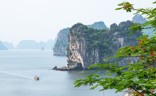 Scenic view of sea and mountains against clear sky