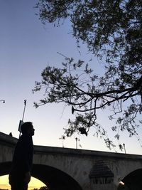 Low angle view of people against clear sky