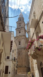 Low angle view of bell tower against sky