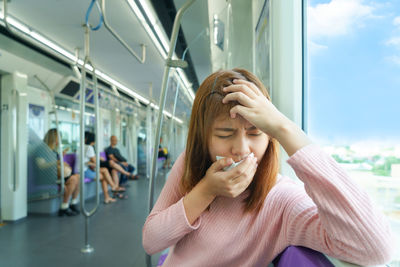 Portrait of woman sitting in bus