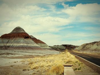 Scenic view of desert road against sky