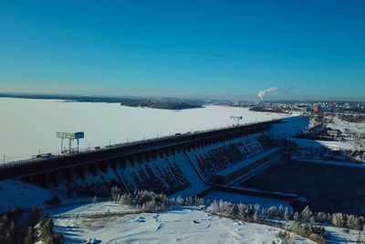 High angle view of bridge during winter against blue sky