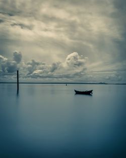 Sailboat in sea against sky