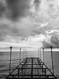 Pier over sea against sky