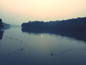 Scenic view of lake at sunset