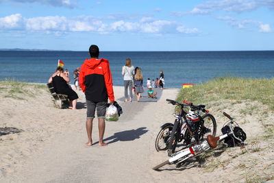 Rear view of people on beach